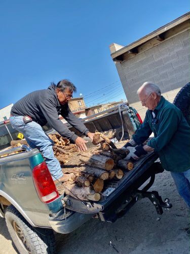 Hopi winter heat project--unloading wood at home of elder.